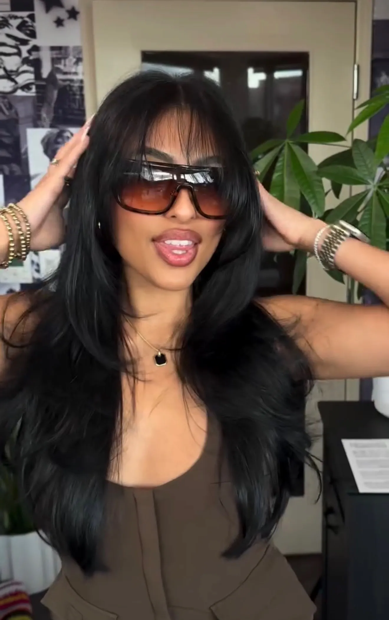 Jet black hair color with curtain bangs and long layers by Alma Juarez at The Mane Allure, Houston