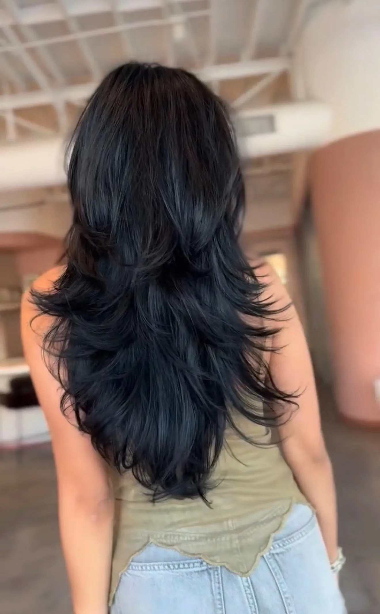Long layered cut on blue-black hair by Alma Juarez at The Mane Allure, Houston